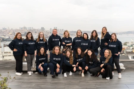 Group photo with city skyline backdrop.